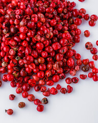 fragrant pink peppercorns on white acrylic background