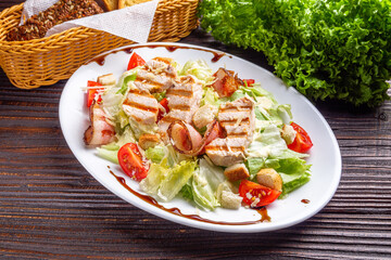 Caesar salad on dark wooden rustic background
