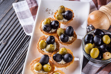 delicious snack tartlets on rustic wooden background