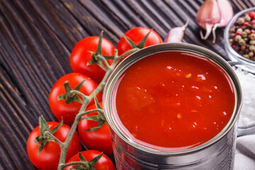 juicy canned tomatoes on wooden rustic background