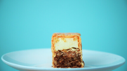 the cut cake rotates on a white plate