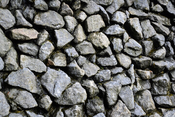 Rocks wall background. Stones wall texture. Artificial waterfall made with natural grey stones. Outdoor nature.