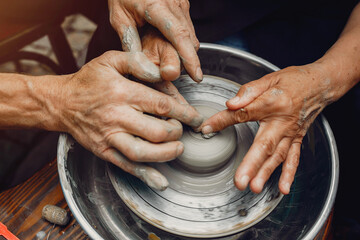 Potter make a small jug. Hands of a potter at work