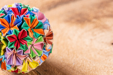 Colorful handmade origami keychain on a wooden background