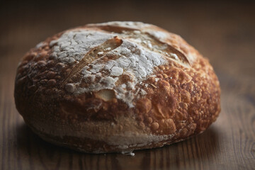 delicious freshly baked rustic bread on wooden table