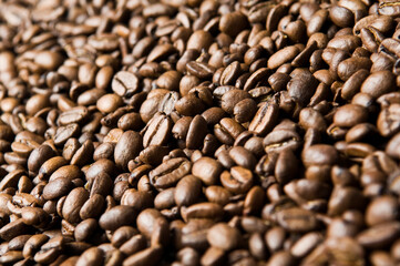 Roasted coffee beans background - full frame detail. Close up of a brown surface texture of aroma black caffeine drink ingredient for coffee beverage