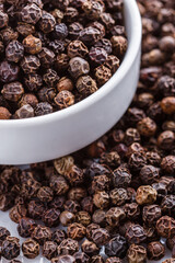 fragrant black pepper on white acrylic background