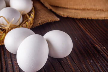 white chicken eggs on wooden rustic background