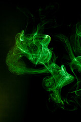 Fototapeta premium Green smoke motion on black background.
