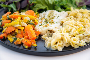 cod fish with vegetables, small vegetables and marine sauce