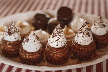 delicious brownies with cream in cone shape on plate