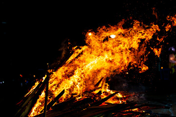 Bonfire that burns on a dark background, wood burning flame.