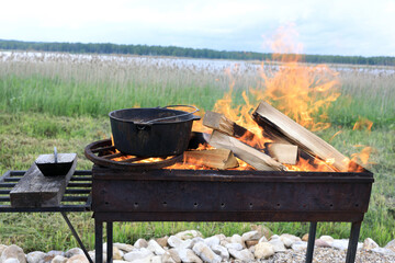 Boiling water in cauldron on fire
