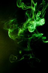 Fototapeta premium Green smoke motion on black background.