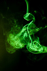 Fototapeta premium Green smoke motion on black background.