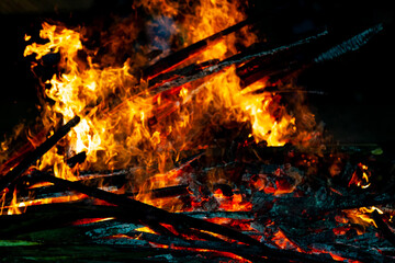 Bonfire that burns on a dark background, wood burning flame.
