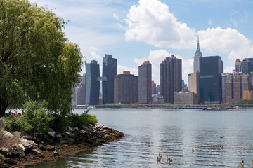 Riverfront of Gantry Plaza State Park in Long Island City Queens New York with a view of the Midtown Manhattan Skyline during Spring