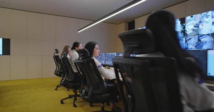 Security control room operator at work, Security System Operator Looking At Cctv Footage