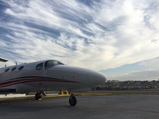 Executive transport aircraft parked at airport at dawn