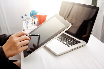 businesswoman hand using smart phone, tablet payments and holding credit card online shopping, omni channel, digital tablet docking keyboard computer at office in sun light