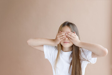 portrait of a girl who closed her eyes with her hands