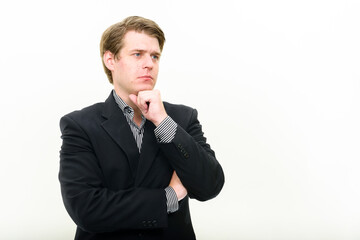 Portrait of young handsome businessman thinking and looking up