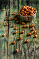 Chickpea snack with baked paprika with green wooden background