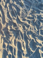 Beautiful wavy sand texture illuminated by sunbeams