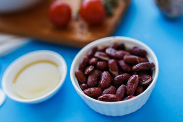 red bean in a plate, closeup. vegetables in the background in blur