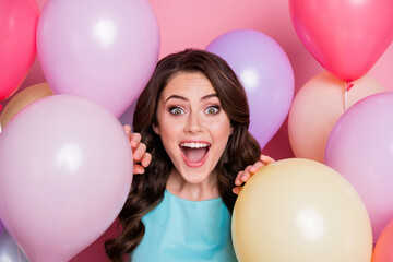 Fototapeta na wymiar Closeup photo of pretty funny surprised lady celebration event party around many air balloons birthday overjoyed emotions wear blue teal dress isolated pink pastel color background