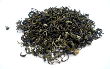 Dry green tea isolated on white with blur effect.