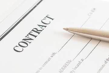metal pen lies on the contract. White background. business agreement.