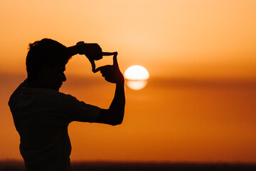 Silhouette of a man in front of the sunset