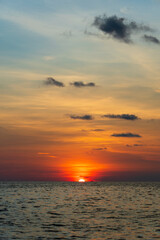 Obraz premium Sunset on the island of Phu Quoc, Vietnam. Travel and nature concept. Evening sky, clouds, sun and sea water