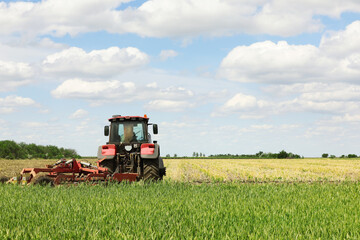 Obraz premium Modern agricultural machinery in field on sunny day