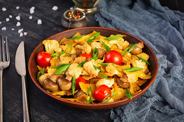 Stir fry farfalle pasta with vegetables, cauliflower and mushrooms