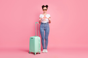 Full length body size view of her she nice attractive lovely pretty cheerful cheery girl holding in hands paper plane departure abroad destination adventure isolated over pink pastel color background