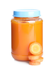 Jar with baby food and carrot slices on white background