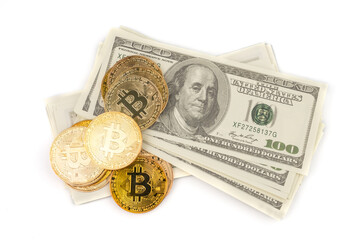 Golden Bitcoins of new digital money on banknotes of one hundred dollars.