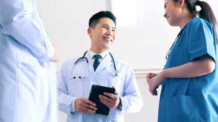 Team of doctors talking in hospital. Group of medical staff discussing in clinic.