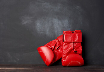 pair of red leather boxing gloves on a black background