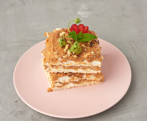 square pieces of meringue cake with cream on a pink plate