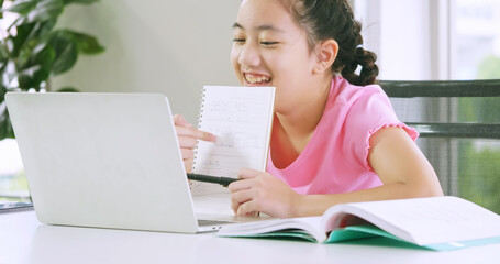 A girl studying online distance learning while quarantine at home.