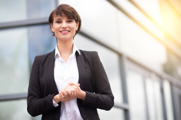 an expressive and happy businesswoman outside