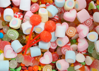 Mixed colorful fruit candies and marshmallow as background