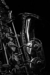 Detail of a saxophone  with dramatic lighting in black and white