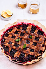 Delicious homemade berries honeysuckle pie on beige linen tablecloth. Selective focus