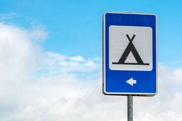 Blue road sign of camping with sky background
