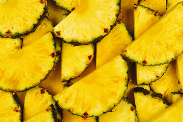 Pineapple juicy yellow slices background. Top view.