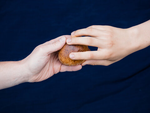 two hands holding bread